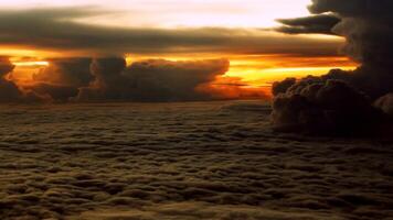 View of the sunset above the clouds as seen from inside the plane photo