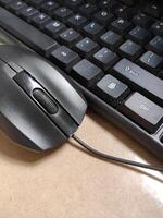 A used computer mouse and keyboard that is already quite dusty. Work from home concept photo