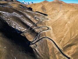 Scenic view of the winding hill road named Pan Long Ancient Road in Tashkurgan, Xinjiang, China. photo