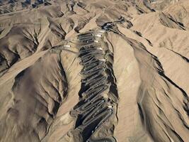 Scenic view of the winding hill road named Pan Long Ancient Road in Tashkurgan, Xinjiang, China. photo