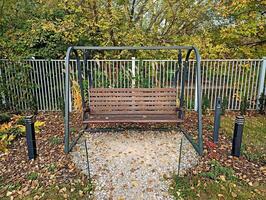 An empty swing bench in the autumn park photo