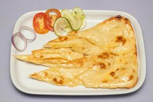Tandoori Butter Nun, or nan with salad served in tray isolated on grey background top view of bangladesh, indian and pakistani food photo
