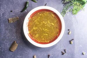 Plain daal, dal dhal or yellow lentils soup served in bowl isolated on grey background top view of bangladeshi food photo
