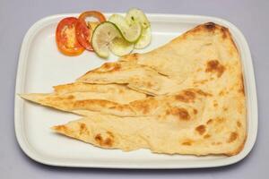 Tandoori Plain Nun, or nan with salad served in tray isolated on grey background top view of bangladesh, indian and pakistani food photo