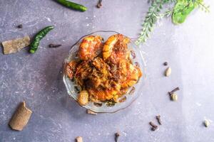 Fried shrimp or Chingri mach with onion served in bowl isolated on grey background top view of bangladeshi food photo