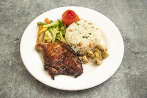 Grilled Chicken Steak with Fried Rice and Veggies Salad served in plate isolated on grey background side view of asian food photo