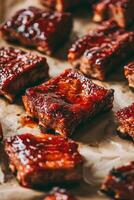 Delicious bbq ribs glazed and resting on baking paper photo
