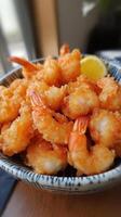 Crispy fried shrimps with lemon slice in a bowl photo