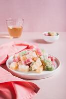Dry frozen gummy bears candies on plate on table vertical view photo