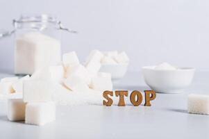 Concept of limited sugar consumption, text and sugar on the table photo