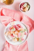 Freeze dried chewy candies on a plate on a table top and vertical view photo