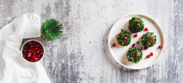 Fish salad in dill on crackers in the shape of Christmas trees on a plate top view web banner photo