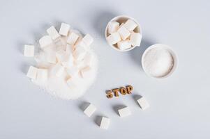 Concept of limited sugar consumption, text and sugar on the table top view photo