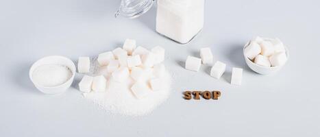 Concept of limited sugar consumption, text and sugar on the table web banner photo