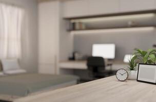 A wooden table with a blurred background of a contemporary bedroom with a workspace. photo