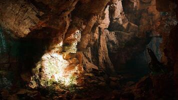 A mysterious cave illuminated by a beam of light photo
