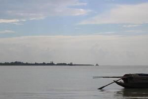 A peaceful scene of a boat gently floating down a calm river photo
