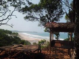 A hut on the beach with a view of the ocean photo