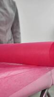 A pink roll of fabric on top of a table video