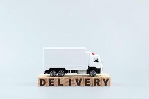 White toy truck on blocks with the text DELIVERY. photo