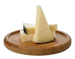 Stack of triangular pieces of cheese on round wooden board, isolated background photo