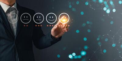 a businessman touching the virtual screen on the happy smile face icon to give satisfaction in service.rating very impressed.customer review service and Satisfaction concept photo