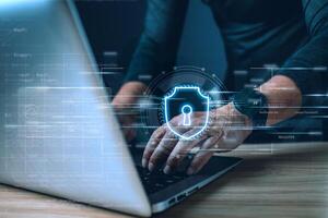 Cyber security and privacy protection network security computer and safe data concept. Businessmen protect personal data information from viruses on a laptop with virtual screen interfaces. photo