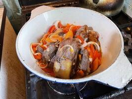 Preparing a homemade veal stew with vegetables photo