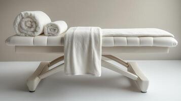 Empty white massage table with towels. Concept of wellness, spa, and relaxation photo