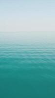 Aerial vertical view on calm azure sea. Small waves on water surface in motion blur. Nature summer ocean sea beach. Nobody. Weather and climate change. Holiday, vacation and travel idea. video