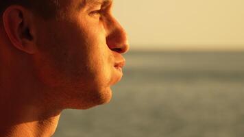 Man Ocean Sunset - Profile of a man looking out at the ocean during sunset. video