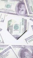 A folded dollar bill is placed on top of a pile of money video