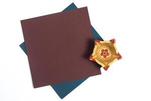 Golden Diya with Blank Paper Card for Diwali Message on White Background photo