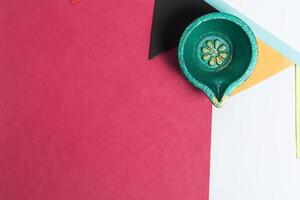 Blank Colored Paper Note with Festive Diya and Decorative Flag on White Background. Diwali Celebration. Place for text. photo