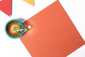 Top View of Colorful Diwali Oil Lamp with Vibrant Papers for Festive Celebration photo