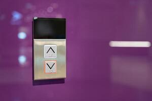 Elevator button on purple wall. Elevator Button up and down direction with copy space. photo