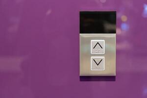 Elevator button on purple wall. Elevator Button up and down direction with copy space. photo