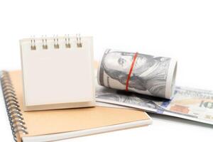 Blank Calendar and US Dollar isolated on white background with copy space. Financial crisis, poverty, lack of money concept. photo