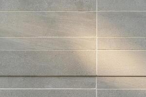 Tile wall for background, marble tile wall pattern with sunlight, for Interiors design. copy space for text. photo