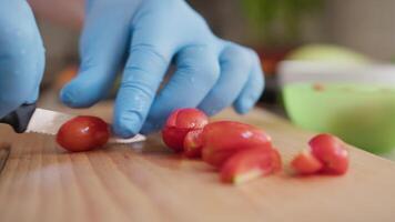 Chef Cuts Red Cherry Tomatoes On A Wooden Cutting Board video