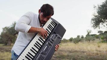 Keyboard Player Standing In Nature With Olive Trees In Calabria video