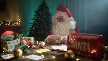 Santa Claus Is Reading Christmas Letters On His Office Desk At Night Time video