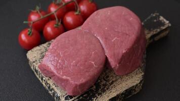Raw beef eye steak round with salt, spices and herbs prepared for grilling video