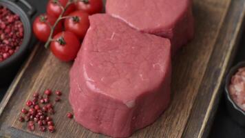Raw beef eye steak round with salt, spices and herbs prepared for grilling video