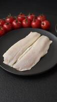 Herring fillet salted and marinated with salt, spices and oil on a dark concrete background video