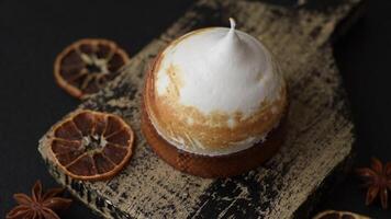 Sweet lemon tart with cream filling and zest on a dark concrete background video