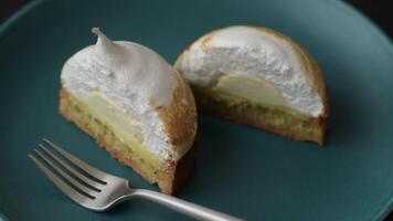 Sweet lemon tart with cream filling and zest on a dark concrete background video