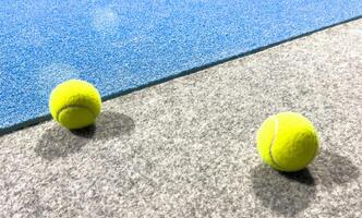 Blue paddle court, with balls. With view of the net and the lines photo