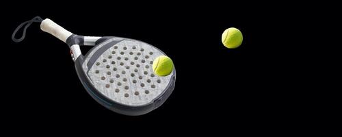 Detailed background of black and white padel racket and ball on black background. Top view. photo