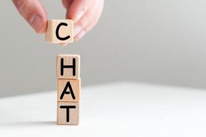 Chat sign on a worn wooden table with a blurry background in bright colors. Concept image a wooden block and word - Chat on white background. The cubes are located on the keyboard photo